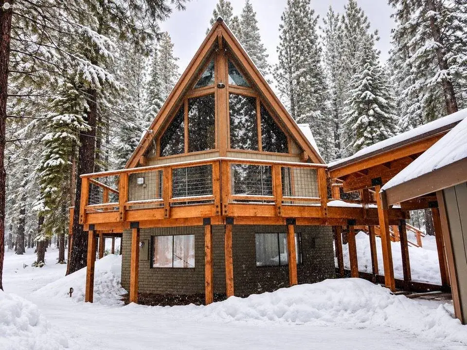 A-frame short-term rental in a snowy pine forest